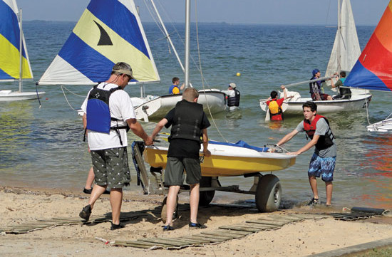 Sea Scouts launch a small boat at the Sailoree. Photo By Capt. Bob Webb